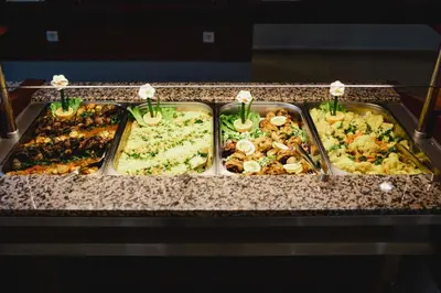 a buffet line with many different types of food at Sun Palace Hotel - All Inclusive in Sunny Beach