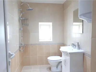 a bathroom with a toilet and a shower and a sink at Top Center 4-Bedroom Apartment in Varna City