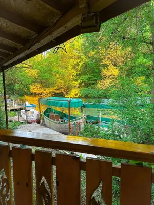 a boat is parked on the side of a river at “River Romance” Villa in Kamchia