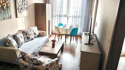 a living room with a couch and a table at Luxury Apartment Azure Coast Panorama in Burgas City