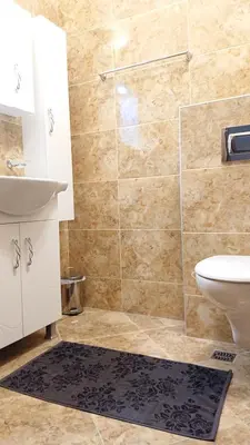 a bathroom with a shower and a sink and a toilet at Luxury Apartment Azure Coast Panorama in Burgas City