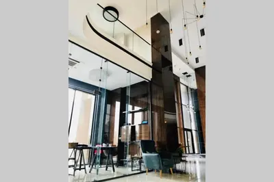 a room with glass walls and a table and chairs at Luxury Apartment Azure Coast Panorama in Burgas City