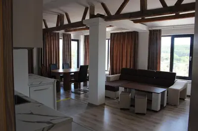 a living room with a couch and a table at Weißer Schwan Белият лебед in Shkorpilovtsi