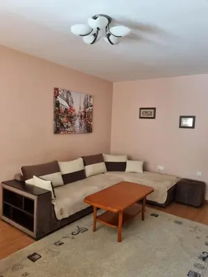a living room with a couch and a table at Нашето място in Pomorie