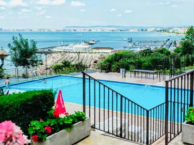 a swimming pool with a view of the water at Dolce Vita sea view apartment in Sveti Vlas