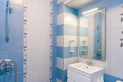 a bathroom with a toilet and a sink and a mirror at Апартамент в жълто in Burgas City