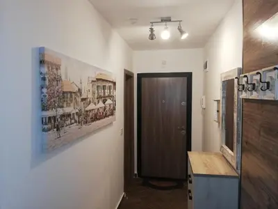 a hallway with a door and a painting on the wall at Апартамент за гости ВО1 in Burgas City