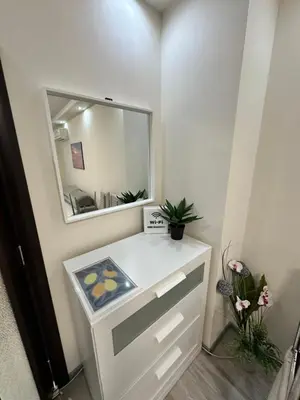 a bathroom with a white vanity with a mirror at Apartment in Varna City