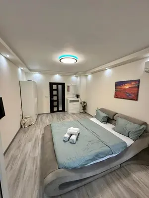 a bedroom with a large bed with towels on it at Apartment in Varna City