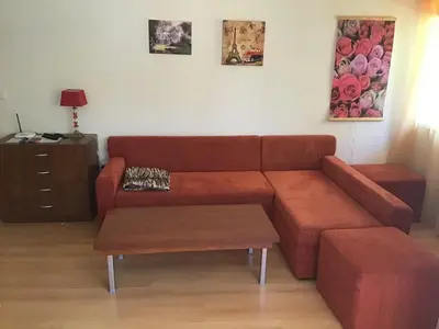 a living room with a brown couch and a coffee table at SunnySeasons Apartment with swimming pool view in Byala