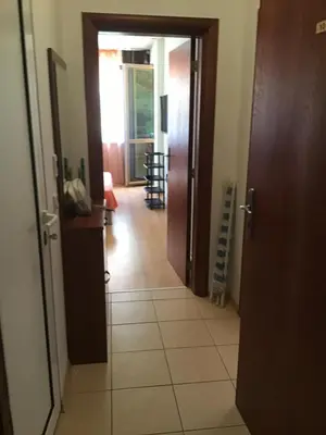 a hallway with a door leading to a room at SunnySeasons Apartment with swimming pool view in Byala