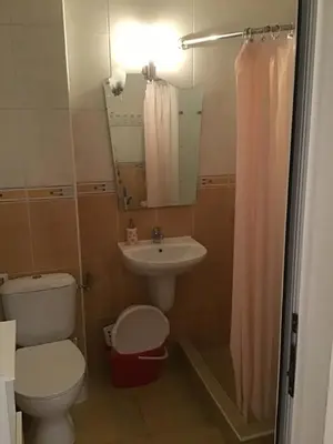 a bathroom with a toilet and a sink at SunnySeasons Apartment with swimming pool view in Byala