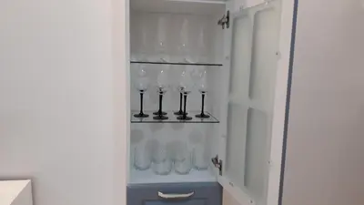 a bunch of wine glasses hanging on a wall at Студио Сънрайз А28, Лозенец in Lozenets