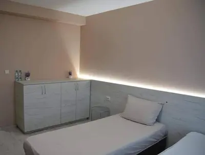 a white couch with a pillow on it in a room at Стаи за гости Гебедже in Beloslav
