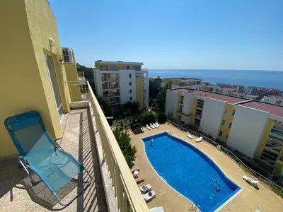 a view of a swimming pool on a balcony of a building at Sea View Panoramic Apartments, Fort Noks Crown Club in Sveti Vlas