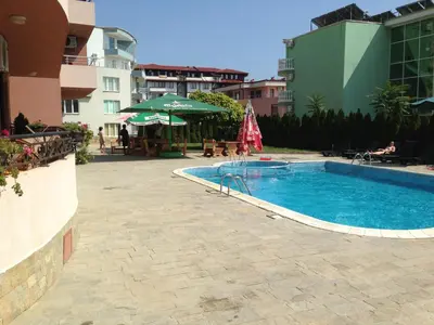 a swimming pool in a courtyard with a building at Femili Hotel Diveda in Sveti Vlas