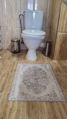 a bathroom with a toilet and a rug on the floor at Horizon Katrina Apartments - Sea line & Beach Access in Sveti Vlas