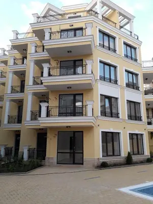 a large yellow building with balconies on it at Horizon Katrina Apartments - Sea line & Beach Access in Sveti Vlas