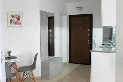 a kitchen with a table and a small table and a door at Horizon Katrina Apartments - Sea line & Beach Access in Sveti Vlas