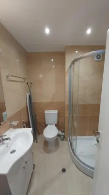 a bathroom with a toilet and a shower and a sink at Ravda on the Beach in Ravda