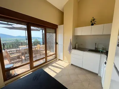 a kitchen with a view of a balcony at Santa Marina resort Sozopol - penthouse with amazing sea view in Sozopol