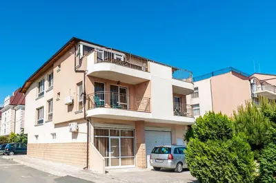an apartment building with a car parked in front of it at House Apartments Black sea Hotel in Obzor