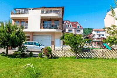 a building with a car parked in front of it at House Apartments Black sea Hotel in Obzor