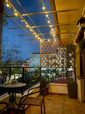 a patio with a table and lights on a balcony at Sozopol Dreams apartman 42 in Sozopol