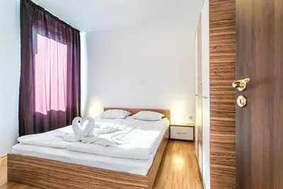 a bedroom with a bed with two swans on it at Admiral Plaza Hotel in Sunny Beach