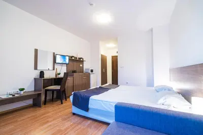 a bedroom with a bed and a desk and a computer at Admiral Plaza Hotel in Sunny Beach