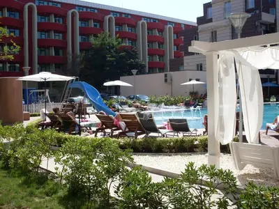 a resort with a pool and chairs and a slide at Admiral Plaza Hotel in Sunny Beach