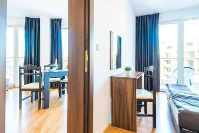 a living room with a table and a dining room at Admiral Plaza Hotel in Sunny Beach