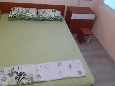 a bedroom with a bed and a dresser and a bed sidx sidx at Varna beach in Varna City