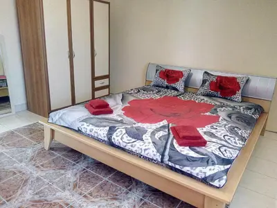 a bedroom with a bed with two red roses on it at гостевой дом у Снежаны in Provadiya