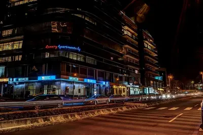a city street with cars parked in front of a building at Luxury Apartments Burgas in Burgas City