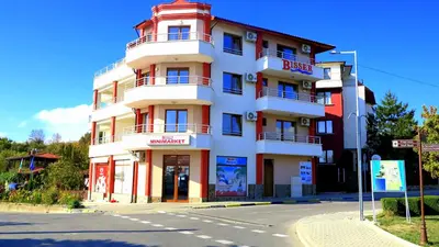 a red and white building on the corner of a street at Bisser Obzor in Obzor