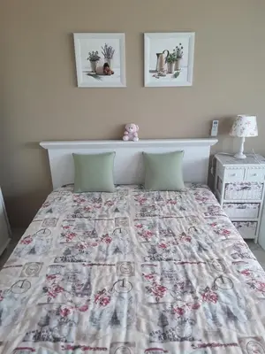 a bed with a quilt on it in a bedroom at PARADISO 'В' 310 Private Room Nessebar in Nesebar