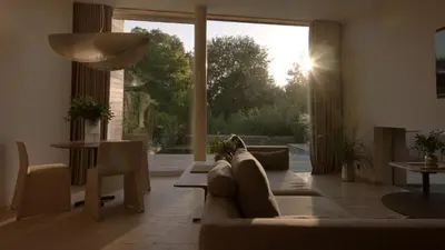 a living room with a couch and a large window at Vaya Beach Resort in Emona