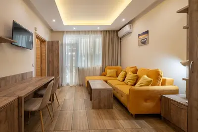 a living room with a couch and a table at Perla Apartments First Line in Nesebar