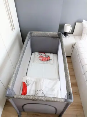 a baby crib in a room with a bed at Apartment SEA HOLIDAYS in Burgas City