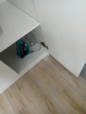 a vacuum in a corner of a room at Apartment SEA HOLIDAYS in Burgas City