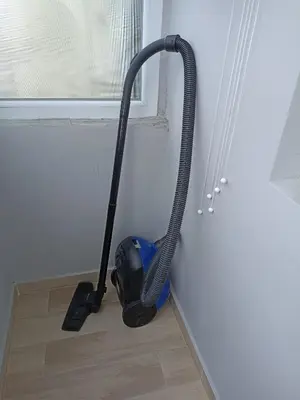 a vacuum cleaner on the floor next to a window at Apartment SEA HOLIDAYS in Burgas City