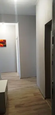an empty room with white walls and wooden floors at Apartment SEA HOLIDAYS in Burgas City