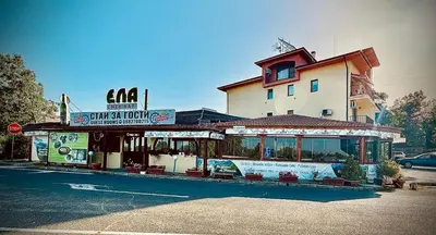 a restaurant on a street in front of a building at Bar & Guests room ELA in Dolen Bliznak
