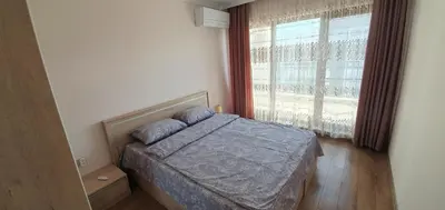 a bedroom with a bed and a large window at CENTRAL Lux Apartment in Varna City