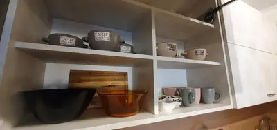 a shelf with cups and vases in a kitchen at CENTRAL Lux Apartment in Varna City