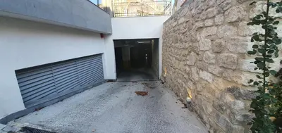 a building with a garage door and a stone wall at CENTRAL Lux Apartment in Varna City