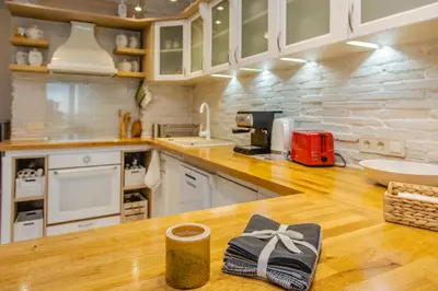 a kitchen with a wooden counter top with a gift on it at Lovely 3BD flat with PARKING and SEA VIEW by Flаt Manаger in Chernomorets