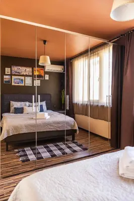 a bedroom with a bed with a glass partition at LunApart in Varna City