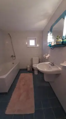 a bathroom with a sink and a tub and a toilet at СЪНТОВЕЦ - на брега на язовир Цонево in Tschenge